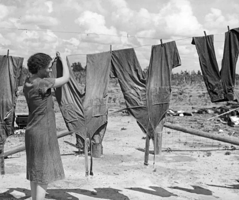  Mrs. Foster hanging up her husband's overalls