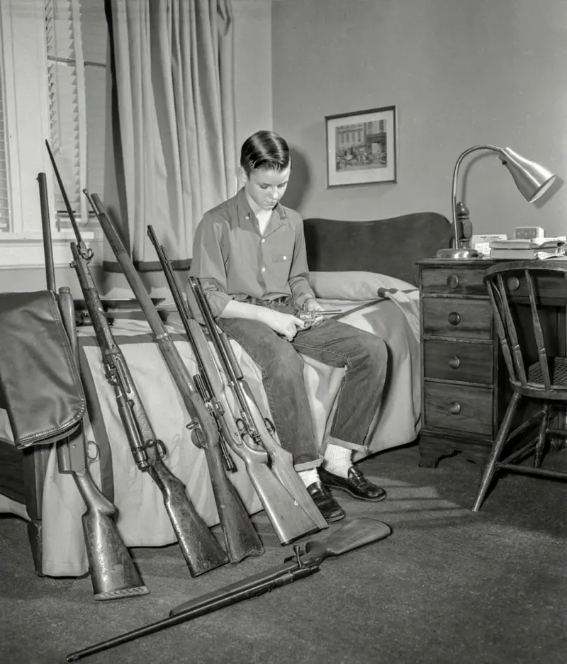 Young Man with His Weapon Collection