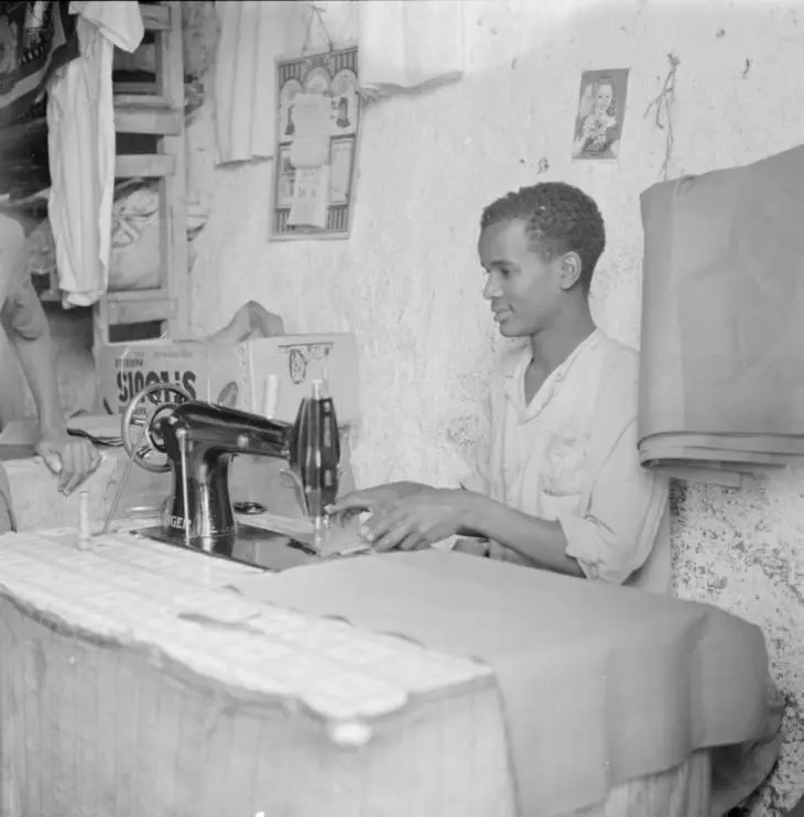 Young tailor working in village shop