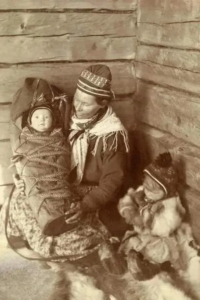 A Sami woman, toddler, and infant 