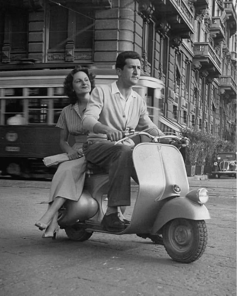 Couple on a Vespa scooter.