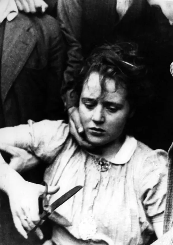 A Dutch woman cuts her hair for her affair with a German soldier