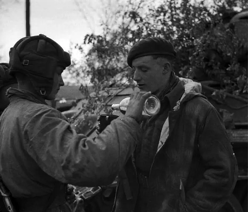 A Soviet tanker treats a British sapper to vodka