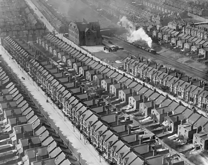 A train passes through densely packed housing 