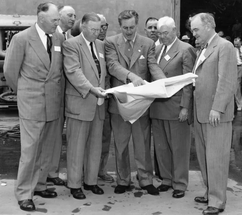 Walt Disney shows the plans of Disneyland to officials from Orange County