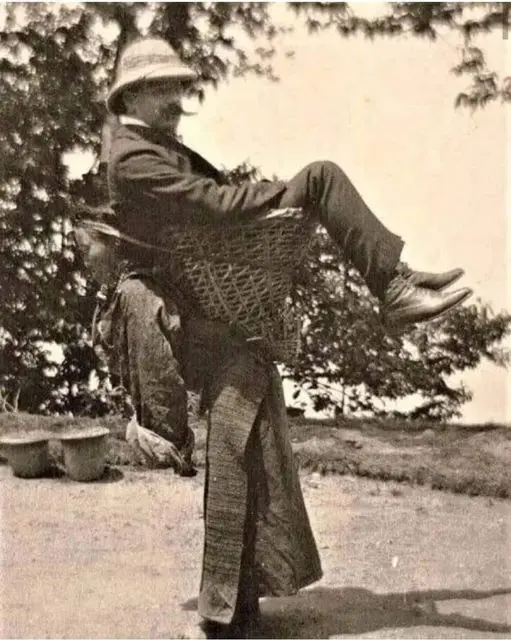 An elderly Bengali woman carrying a British ma
