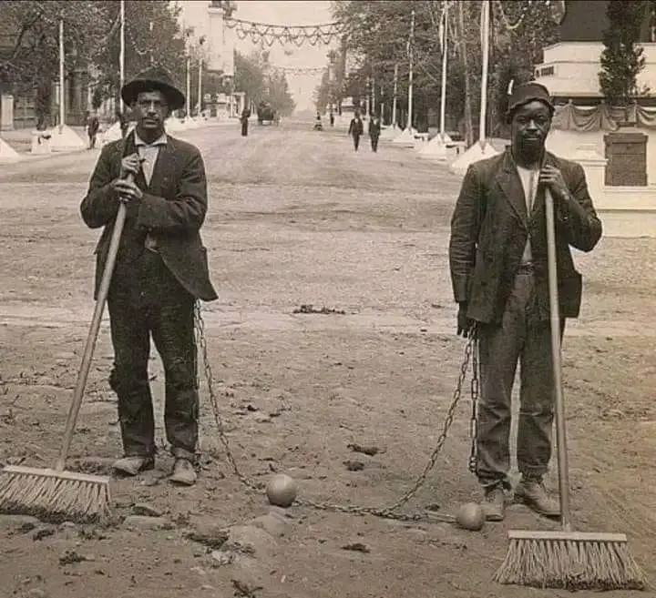 Prisoners sweeping a street