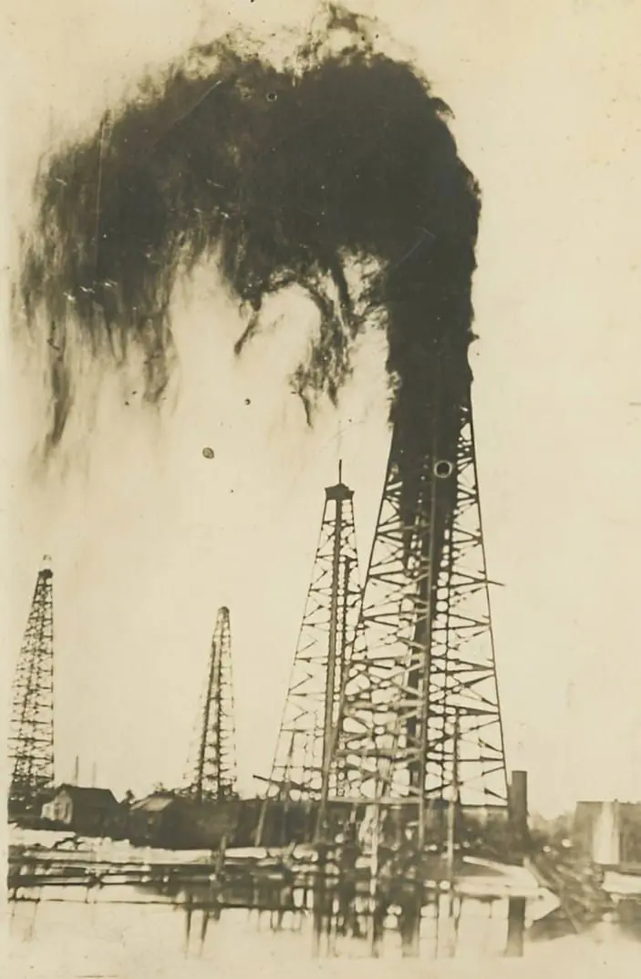 A derrick gushing oil.