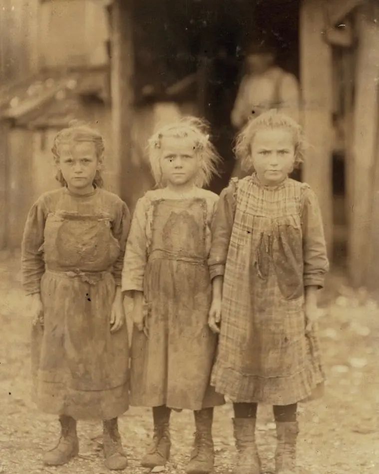 Three young girls working as oyster shuckers. 