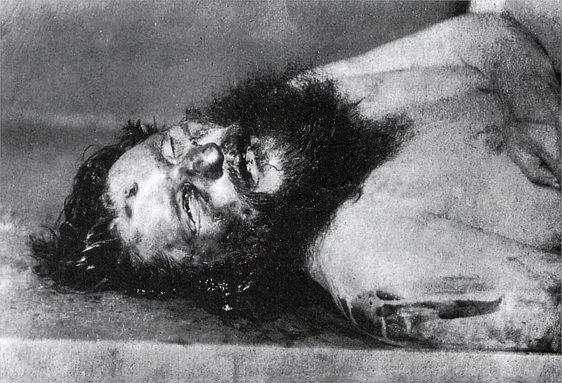 Rasputin's corpse on the ground with a bullet wound visible in his forehead