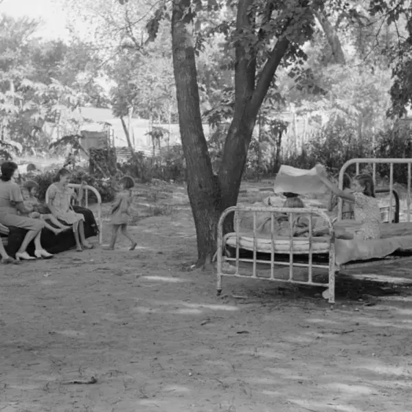 A family relaxing on beds in their backyard 
