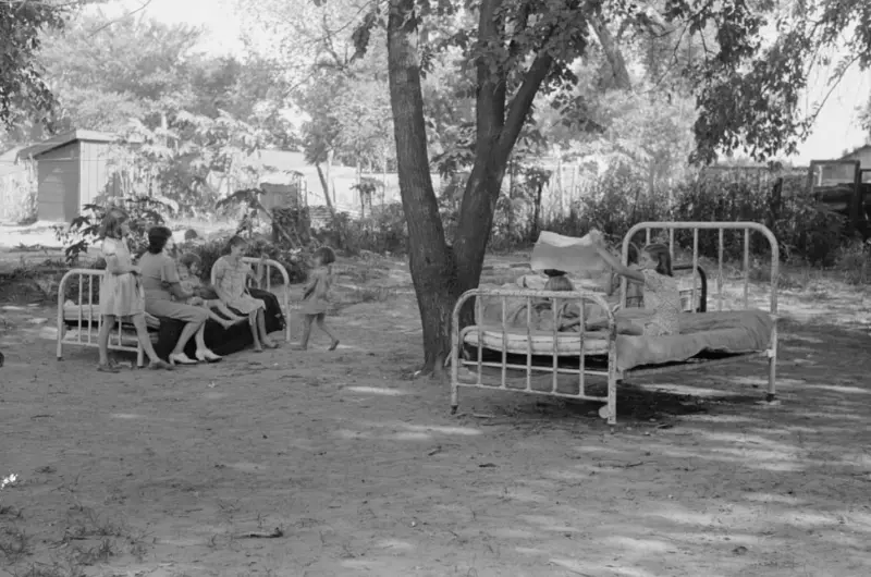 A family relaxing on beds in their backyard 