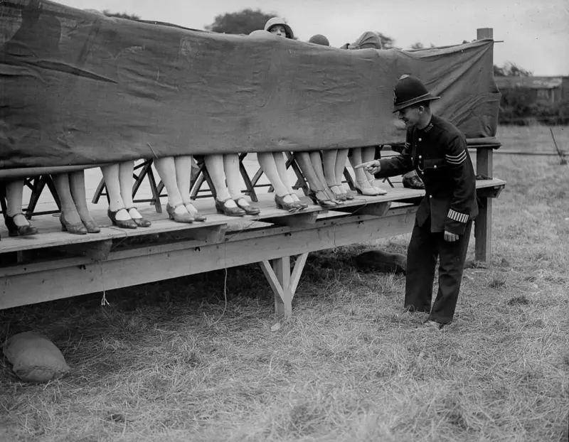 A policeman judges an ankle competition
