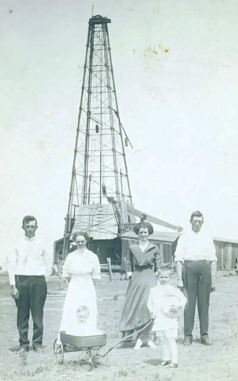 A family in front of an Oil Well