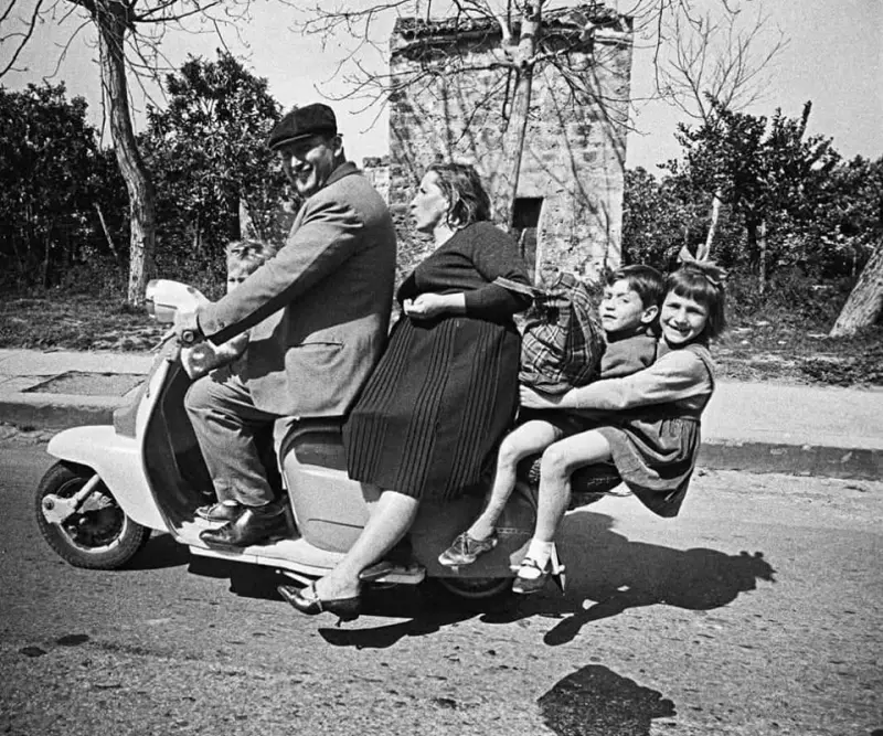 Italian family riding a Lambretta scooter