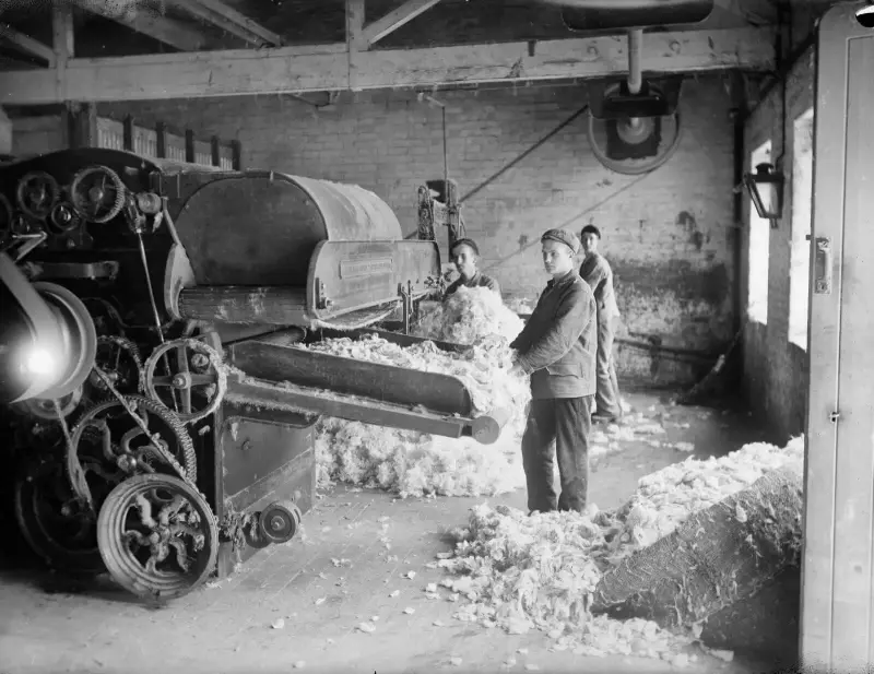 workers attending a machine in Early Blanket Mill