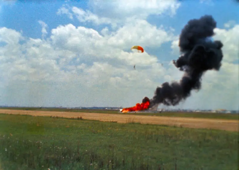 Armstrong descends to the ground on a parachute after ejecting from Lunar Landing Research Vehicle