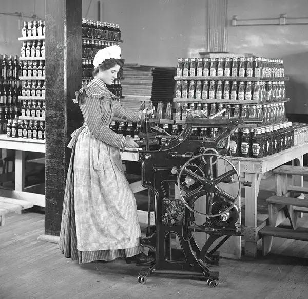 Female worker bottling ketchup at the original Heinz factory