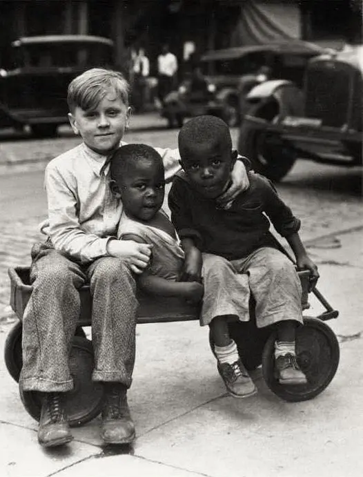 Three young boys sitting in a wagon