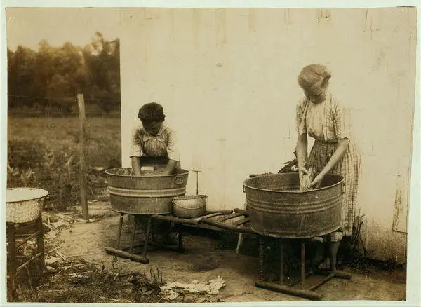 Lester Daniel and 17-year old cousin stripping tobacco.