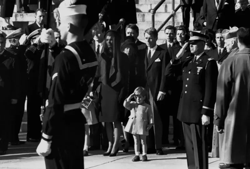John Kennedy salutes his father
