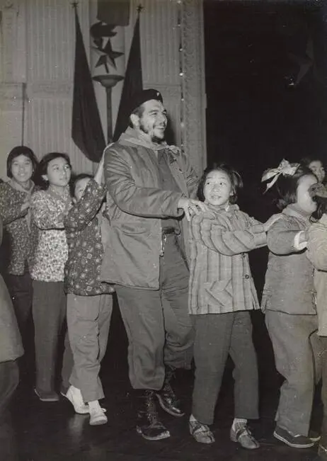Ernesto Che Guevara dances with children at a party