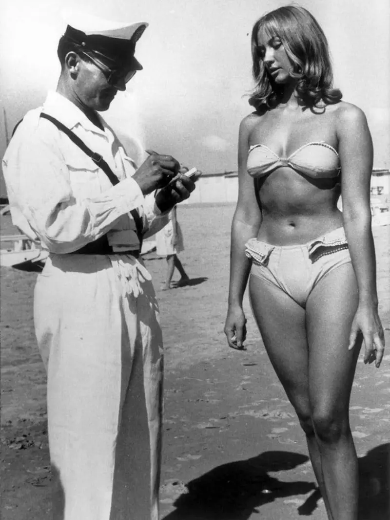 A woman buys a ticket to wear a bikini on the beach