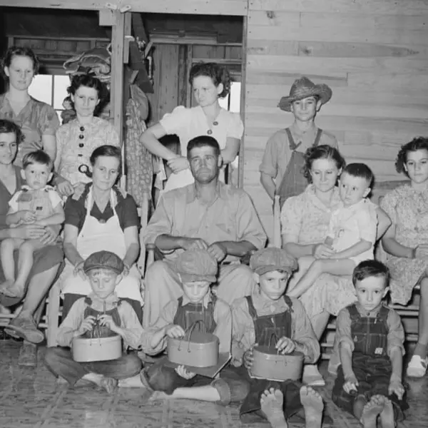 A man with his wife and 13 children