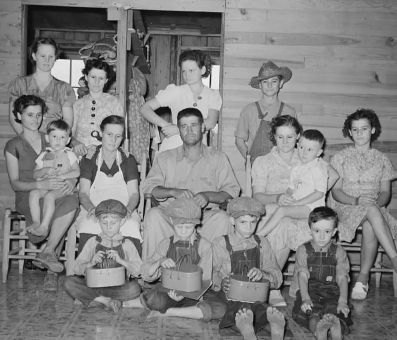 A man with his wife and 13 children