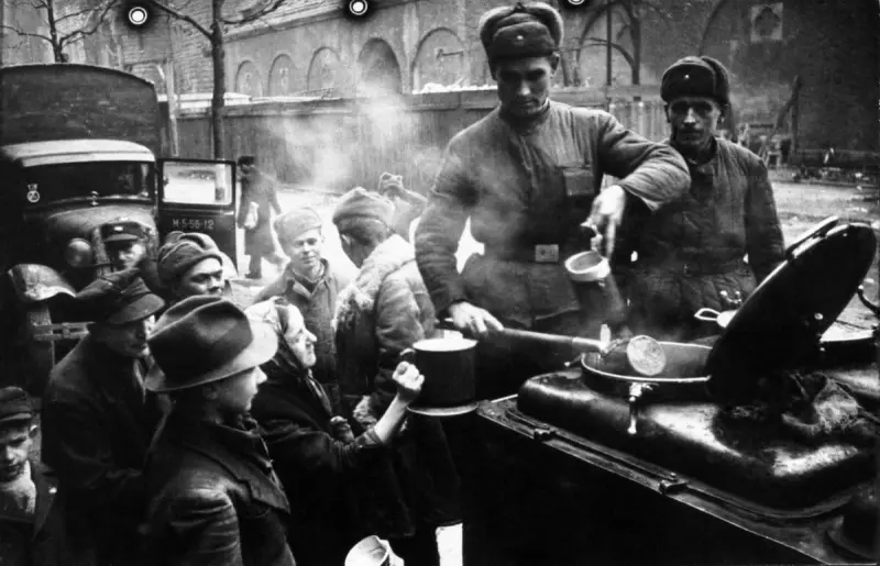 Soviet soldiers feeding the residents