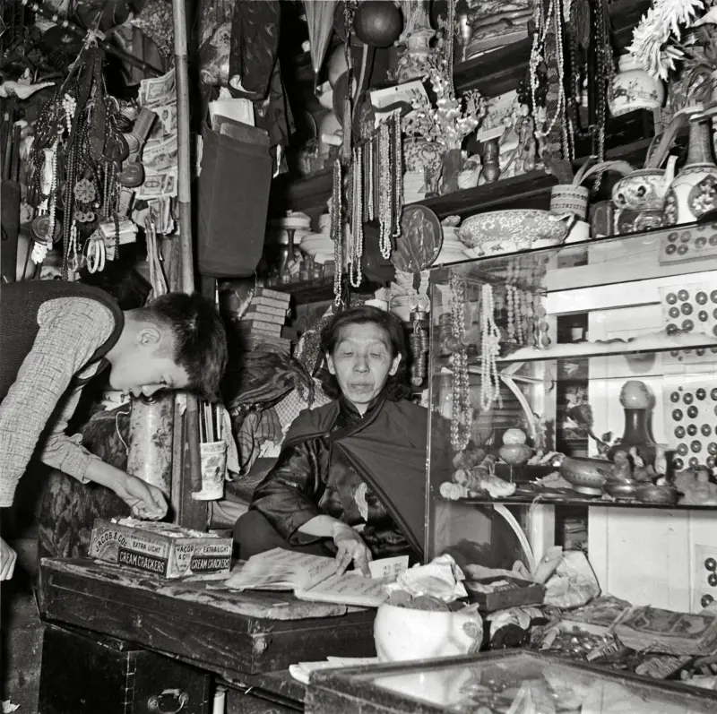 Shopkeeper attends to a customer,