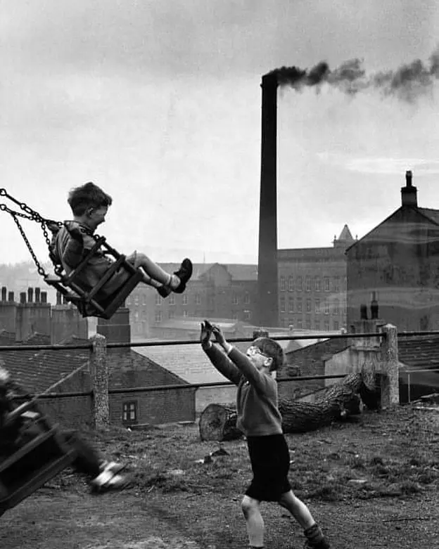 Playing on a swing near factory