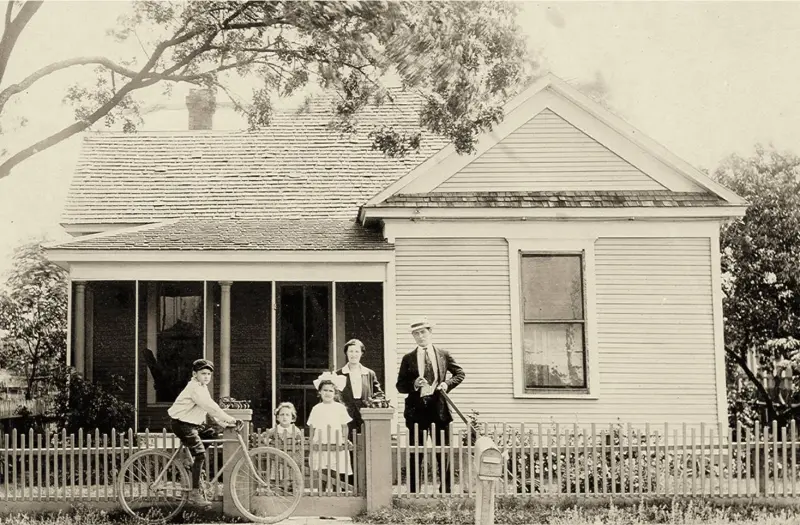 Mr. Joe Meyer and his family outside their home on Harwood Street