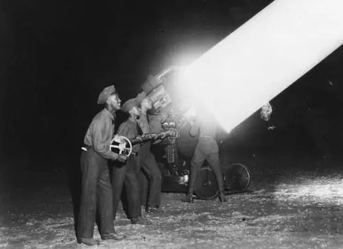 Men operating a searchlight. 