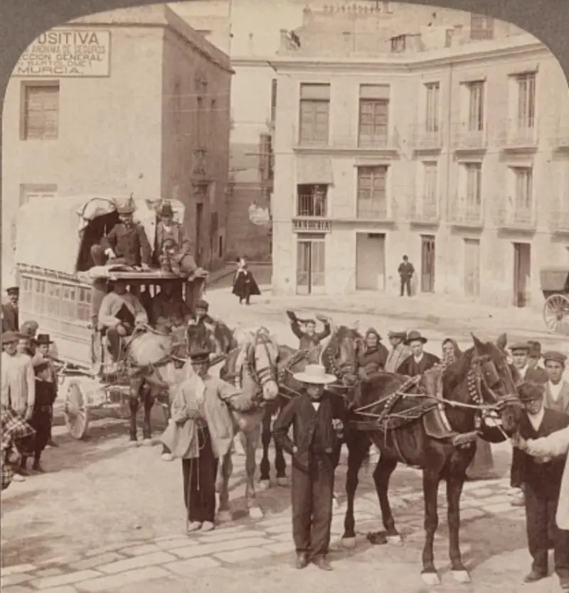 Grupo de personas junto a una diligencia.