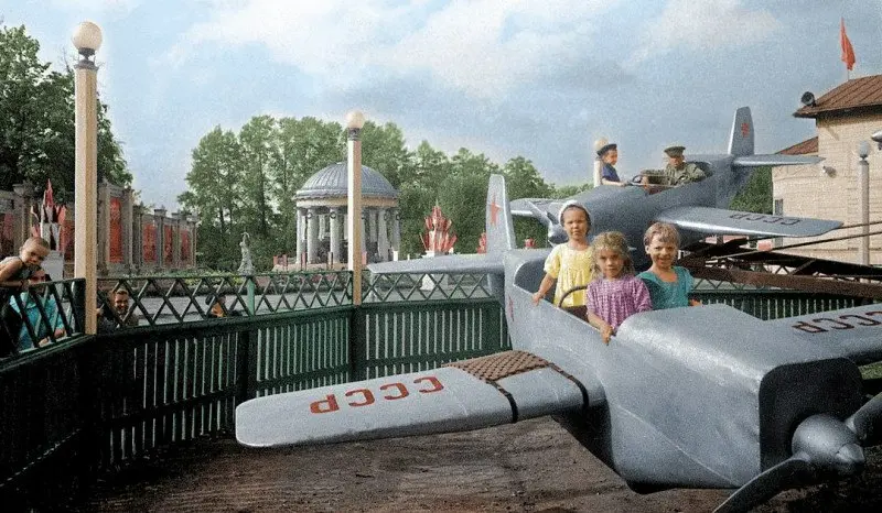 Children on a Plane at an Amusement Park