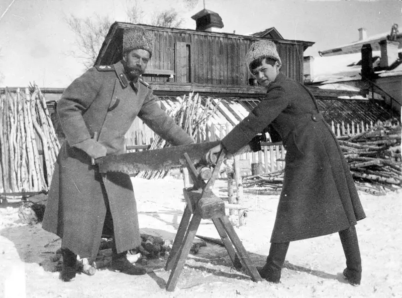 Nicholas II and Alexei sawing wood