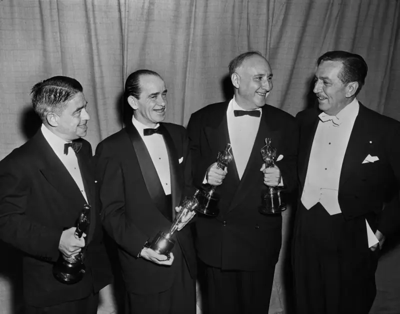 Walt Disney presents Academy Awards to Alfred Newman, Ned Washington and Dmitry Zinovievich Temkin