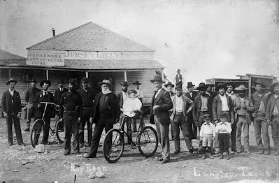 Judge Roy Bean posing with some bicyclists