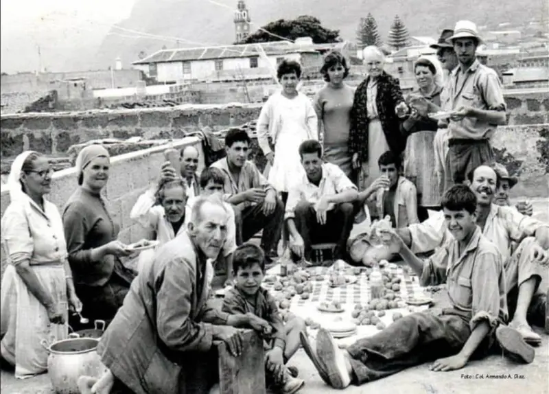 Mantel al suelo con papas, pescado salado y vino