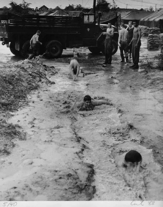 Soldiers swimming in flooded trenches