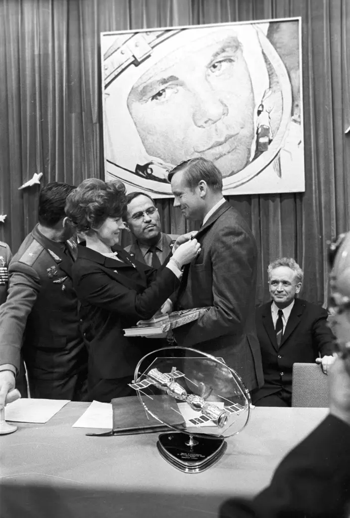 Valentina Tereshkova, the first woman in space, presenting a badge to Neil Armstrong