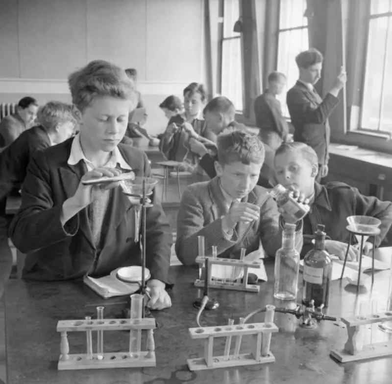 Shoolboys using test tubes