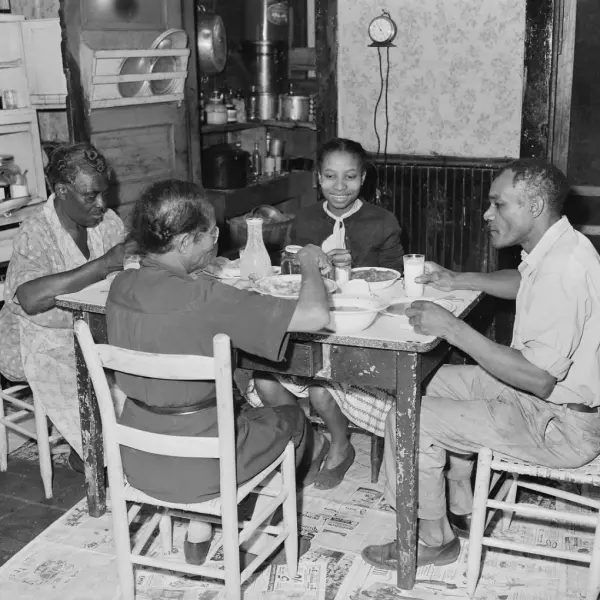 A miner eating supper with his family 