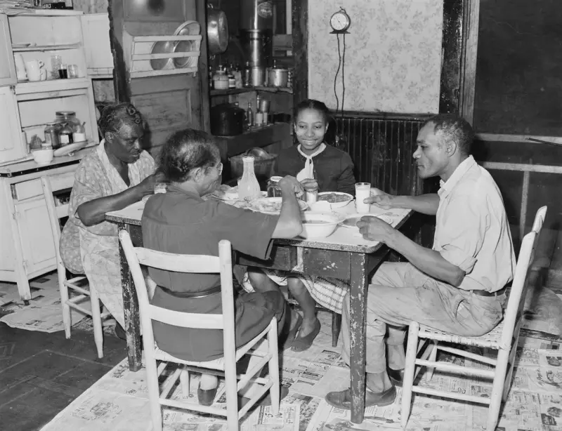 A miner eating supper with his family 