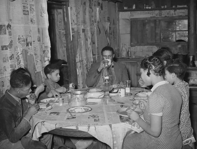 A tenant farmer and his family eating supper