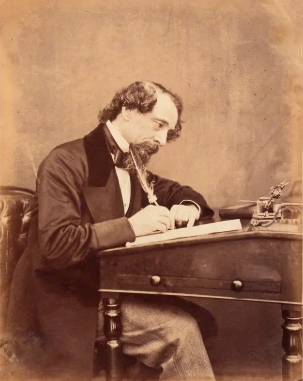 Dickens at his desk