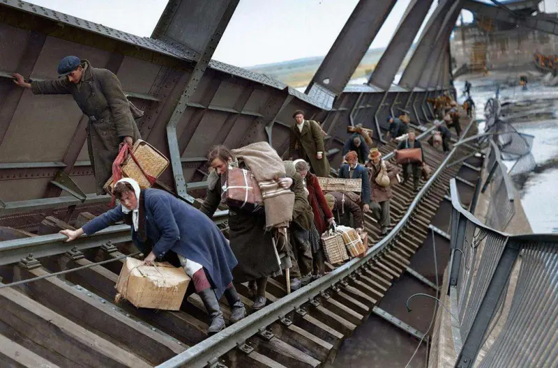 German Refugees Cross the Destroyed Bridge Across the Elbe River