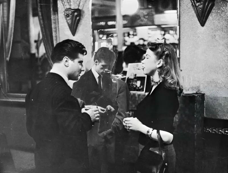 A young man meets his girlfriend in a London pub