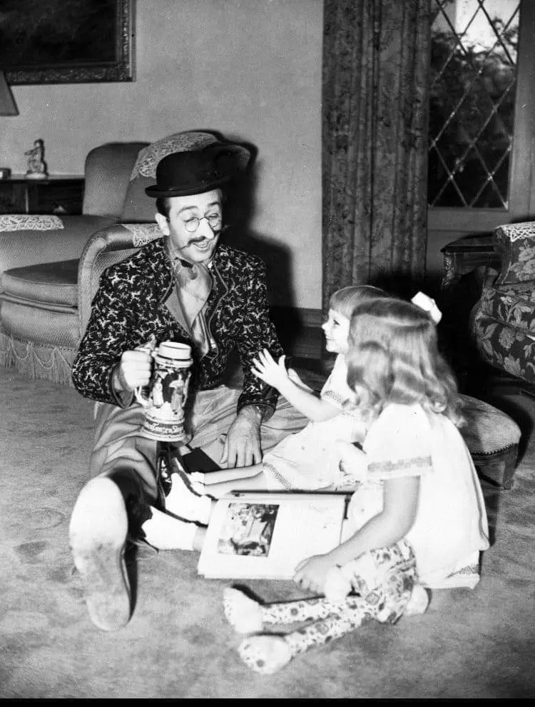Walt Disney plays with his daughters